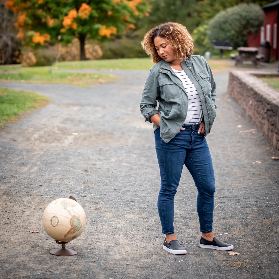 woman-looking-at-globe-outside-fall