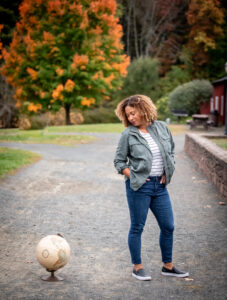 woman-looking-down-at-globe-outside-fall